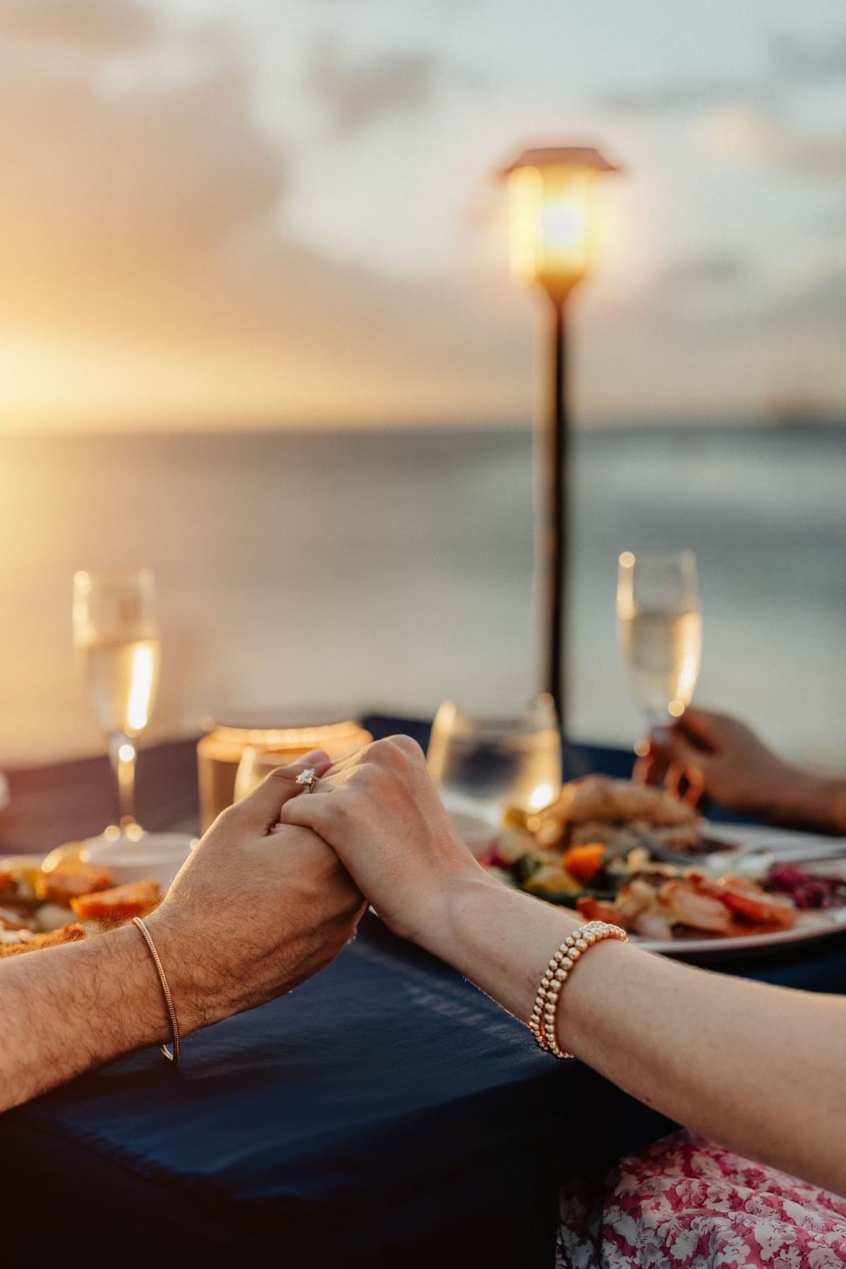 Couple holding hands during a beach wedding celebration